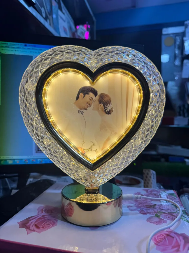Personalized heart-shaped crystal photo lamp with a couple's picture